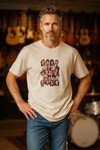 Load image into Gallery viewer, A man wearing a beige graphic t-shirt featuring a graphic print of a loose 4x5 grid of cartoon caricature faces.
